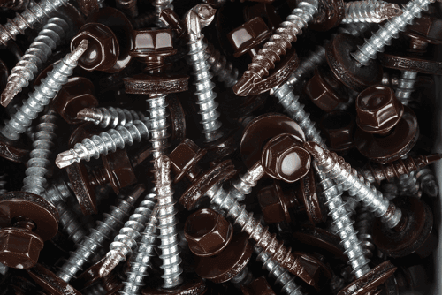 pile of screws as a key component of your material list for metal roofing projects