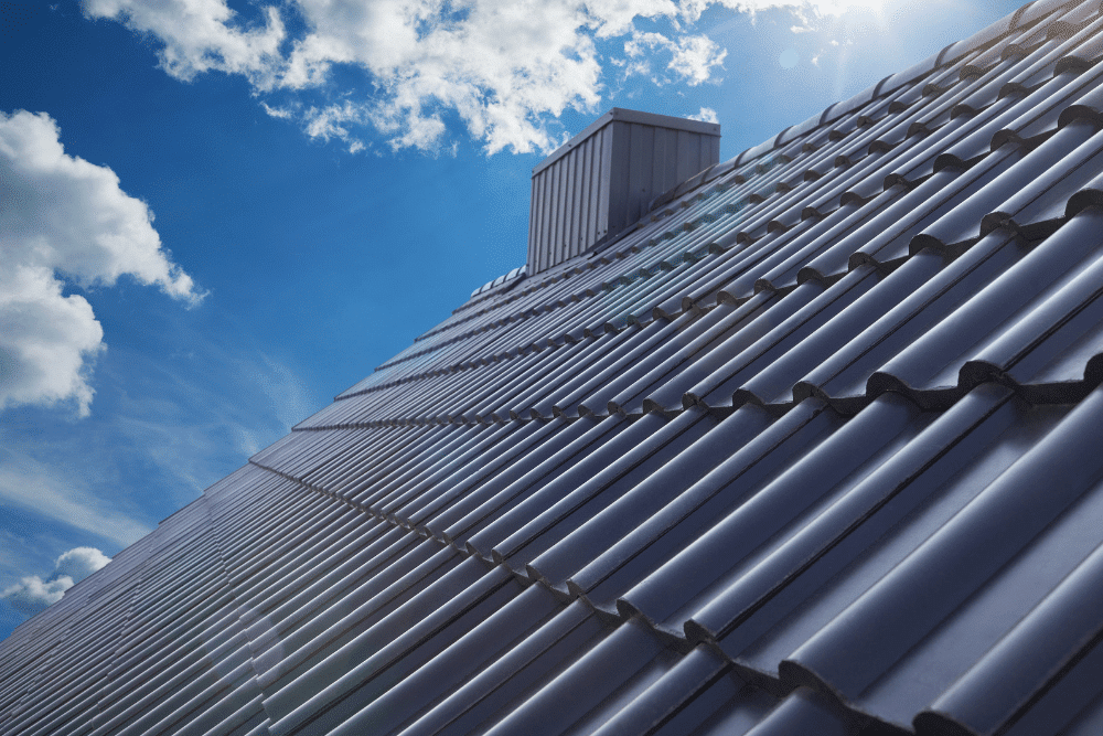 Corrugated Metal Roofing, Metal Roofing In Lacombe, LA, At ADCO Metals. Durable metal roofing with a vent structure under a bright blue sky.