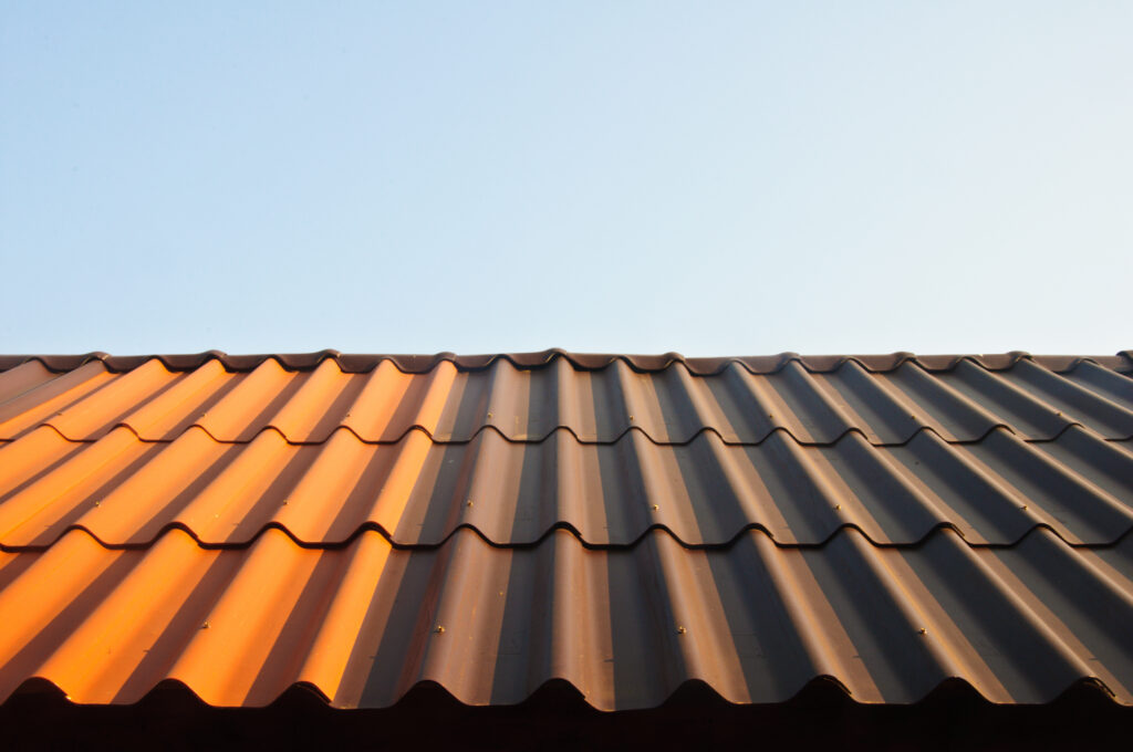 Sun hitting a metal roof showing the answer to the question "do metal roofs reflect heat" is yes