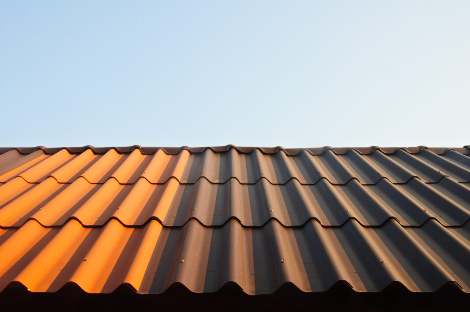 Sun hitting a metal roof showing the answer to the question "do metal roofs reflect heat" is yes