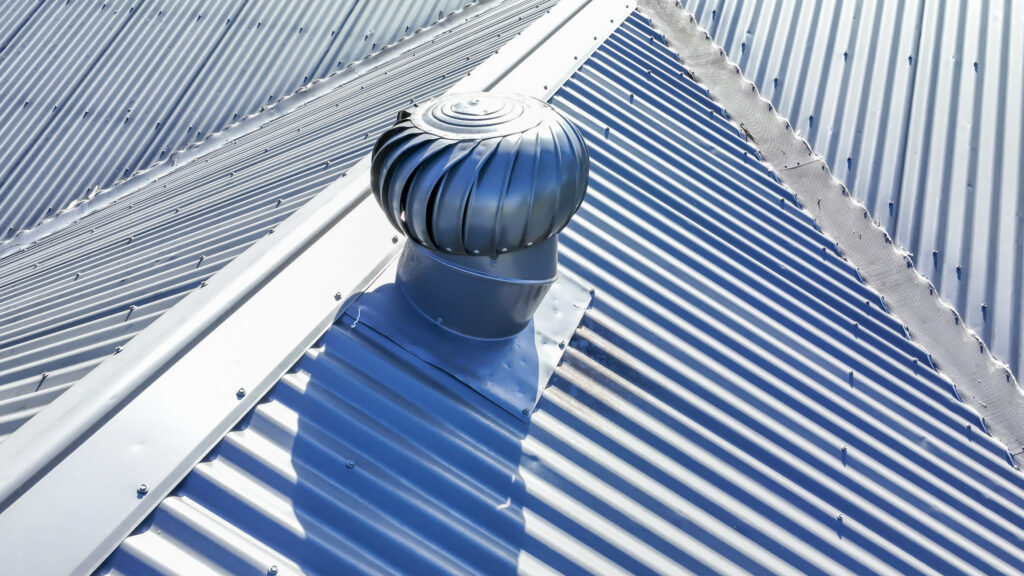 Vent in a metal roof shows the answer to the question does a metal roof need ventilation?