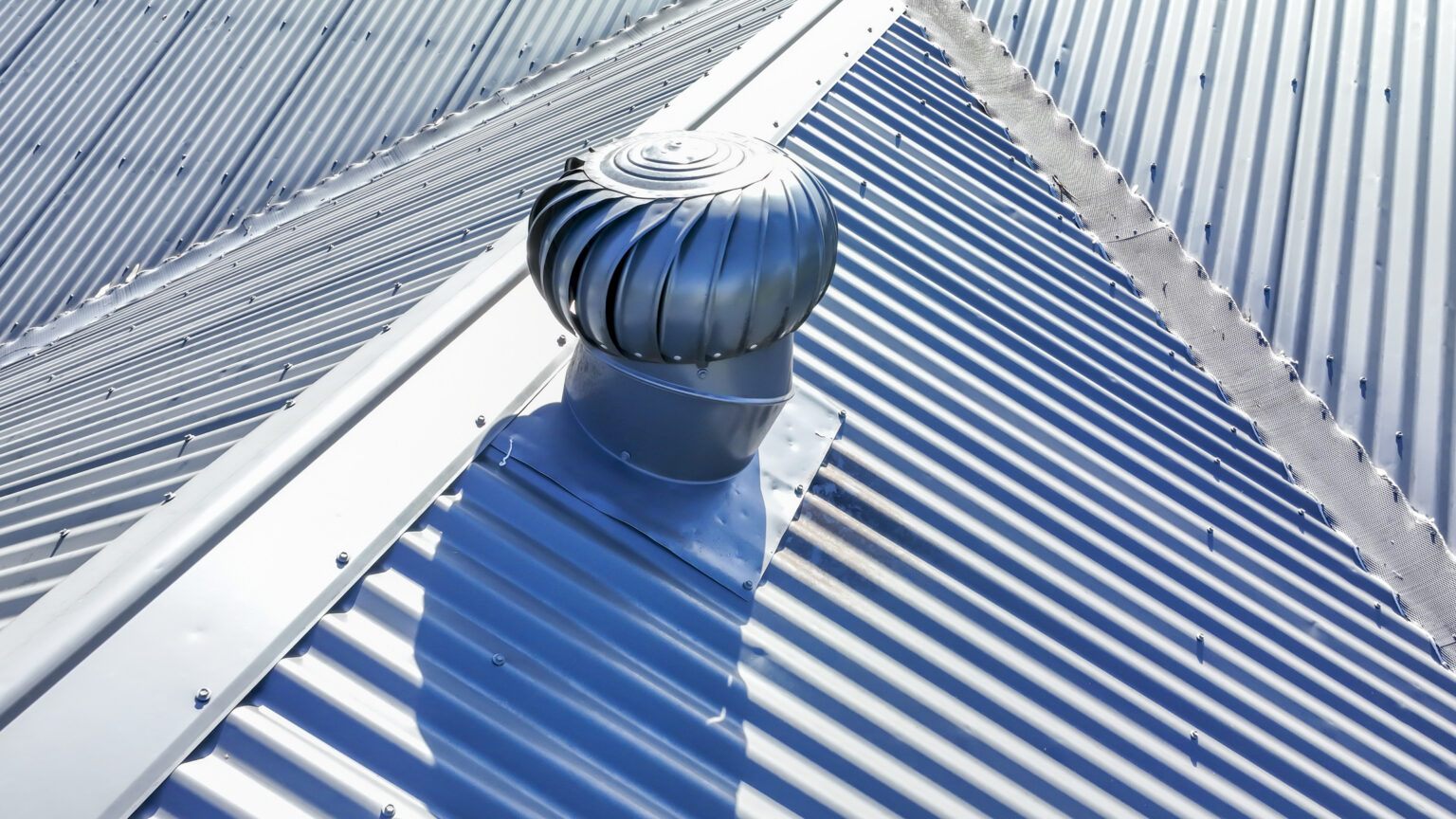 Vent in a metal roof shows the answer to the question does a metal roof need ventilation?